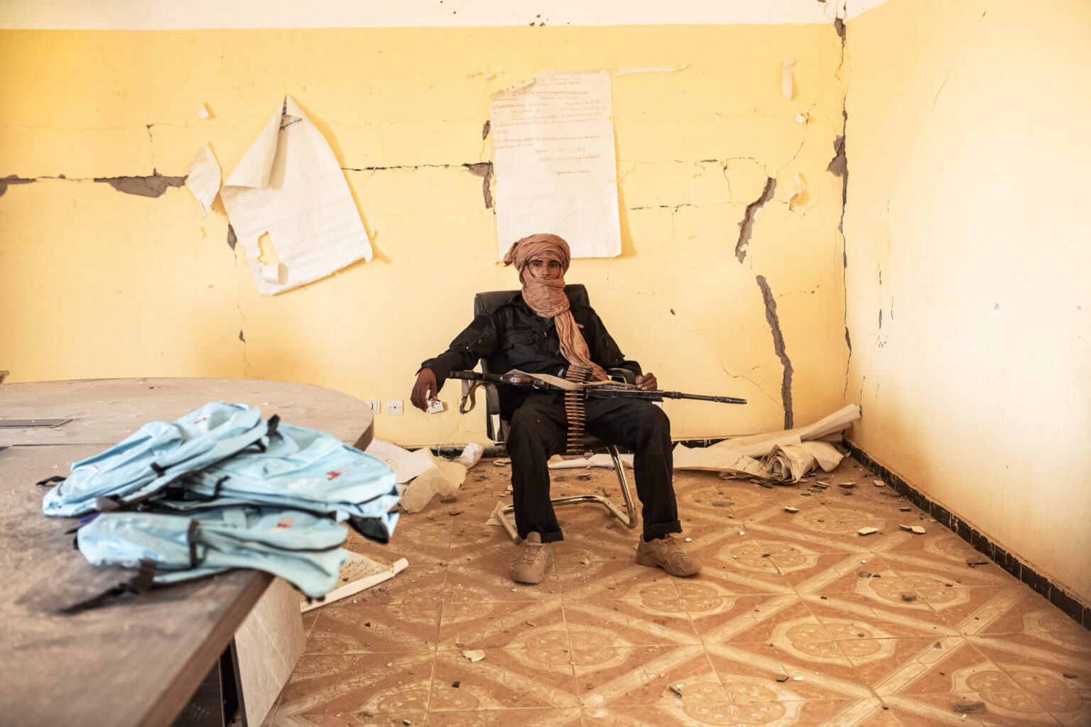 Saïd Ag Madi, 21, a fighter with the Front for the Liberation of Azawad (FLA) Battalion 63-01, rests in a classroom at a school in Kidal, northern Mali. In 2022, he lost his cousin in an ambush near Kidal. His cousin's death led him to join the armed struggle for the Azawad cause.

© Samir Maouche