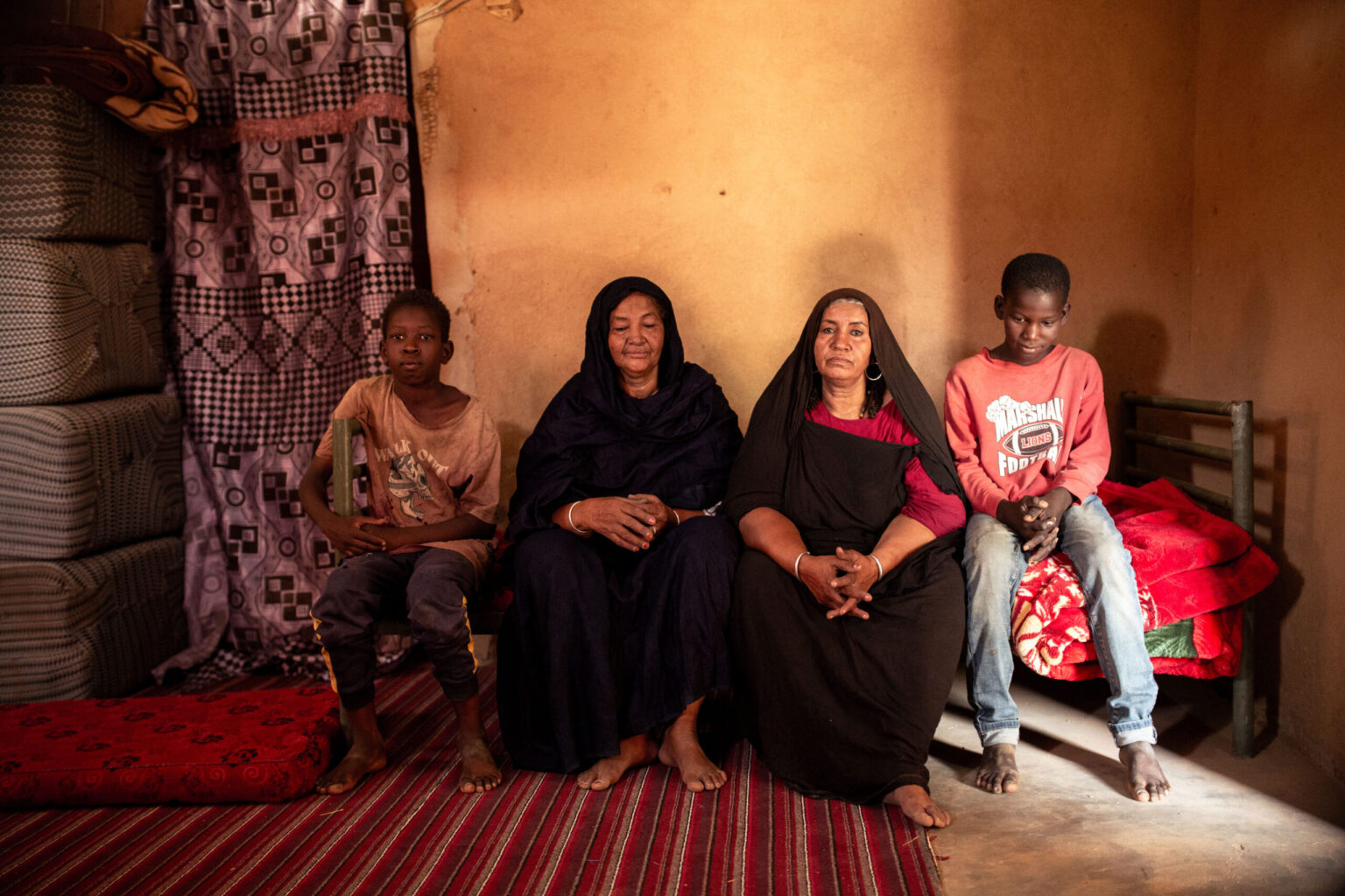 Tita Wallet Assanka poses with two members of her family at her sister's home in Kidal, where she has taken refuge because of the insecurity. According to her testimony, she remained in the city when the Malian army and Wagner Group fighters arrived at the end of 2023. She says her home was searched and looted, forcing part of her family to flee the region. After the Front for the Liberation of Azawad (FLA) regained control of Kidal, some of her relatives gradually returned.

© Samir Maouche