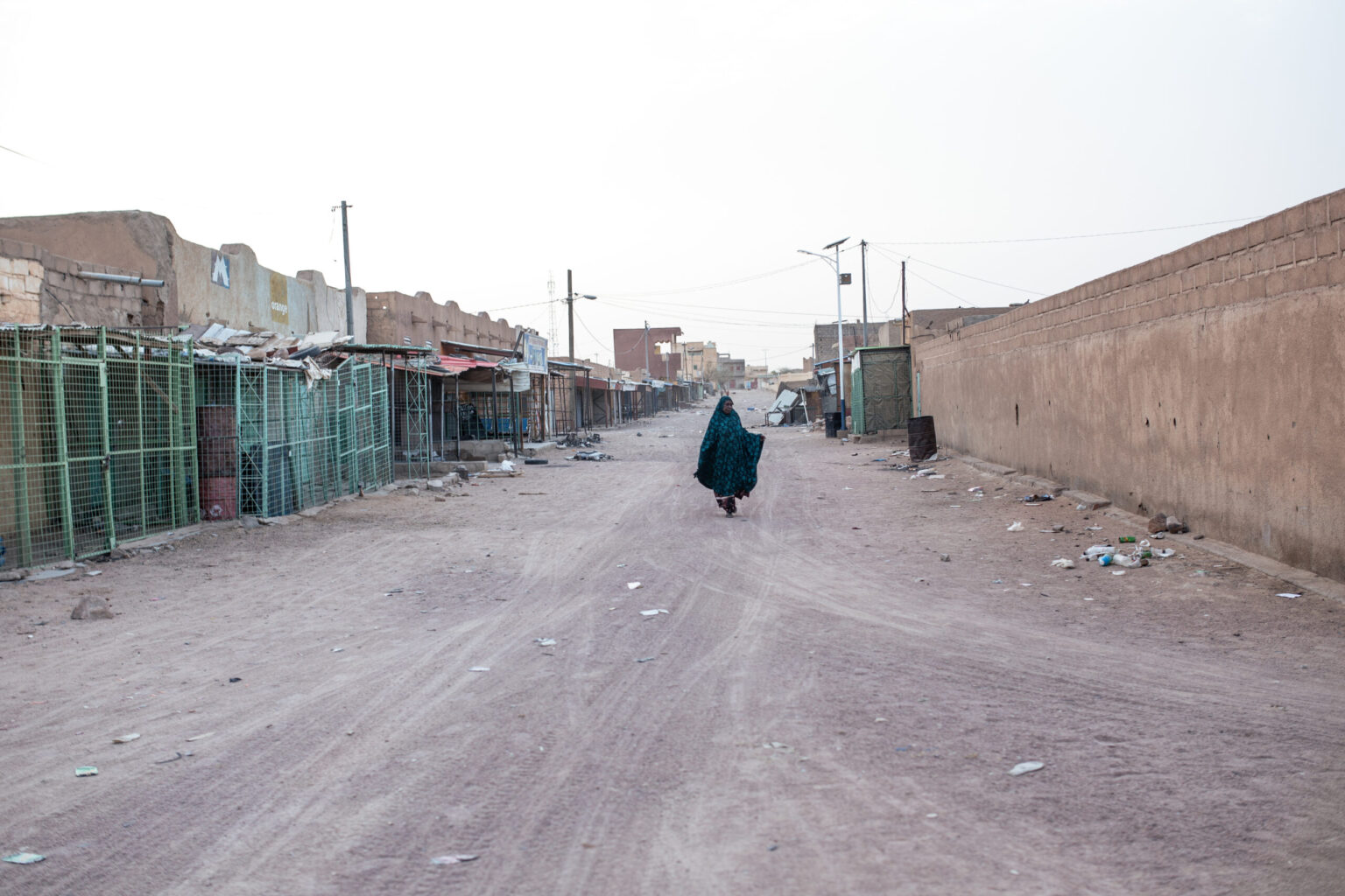 A woman walks along a street in Kidal, northern Mali. Since the Front for the Liberation of Azawad (FLA) took control of the city, many businesses have remained closed. Streets that were once bustling are now almost deserted.

© Samir Maouche